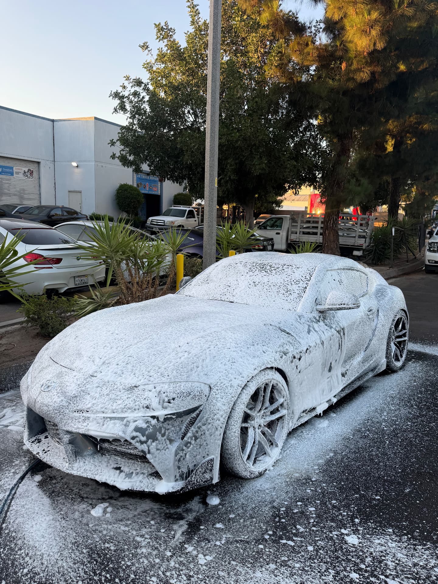 Sports car covered in thick foam during wash